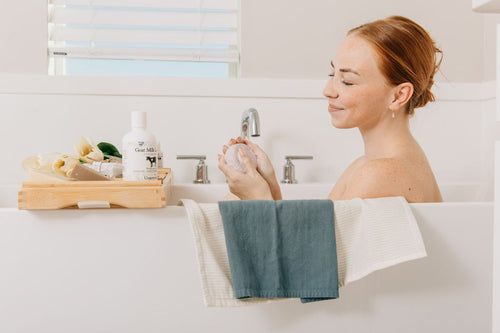 Woman enjoying a bath with soap.