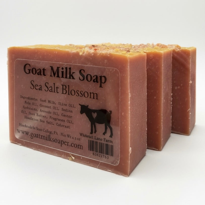 Two bars of goat milk soap with a label on a white background