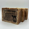 Three bars of Goat Milk Soap with a label on a white background