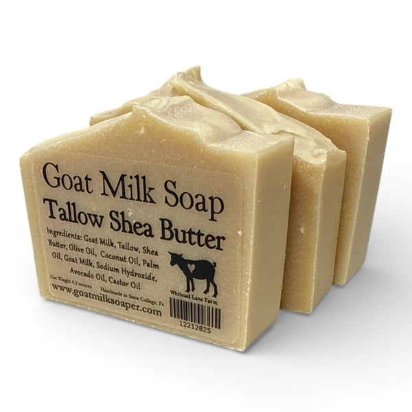 Three bars of tallow Shea butter goat milk soap with a label on a white background