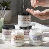 Goat Milk Tallow Cream jars with a hand applying cream.